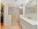 Updated bathroom with glass shower, neutral tiling and vanity with countertop space and storage at 3225 Hargill Dr, Orlando, FL 32806