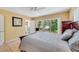 Comfortable bedroom with a large window featuring backyard and lake views and an attached bathroom at 3225 Hargill Dr, Orlando, FL 32806