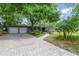 Traditional green home featuring a brick paver driveway and well-manicured landscaping at 3225 Hargill Dr, Orlando, FL 32806