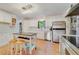 Bright kitchen featuring stainless steel appliances, white cabinetry, and center island at 3225 Hargill Dr, Orlando, FL 32806
