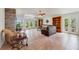 Spacious living room with a stone fireplace, vaulted ceilings, and views of the lake at 3225 Hargill Dr, Orlando, FL 32806