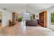 Open layout showcasing the living room's stone fireplace, beamed ceilings, and water view at 3225 Hargill Dr, Orlando, FL 32806