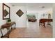 Inviting living room showcasing tile flooring, a decorative mirror, and seamless entryways at 3225 Hargill Dr, Orlando, FL 32806