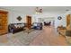 Bright living room with a ceiling fan, bookcases, and a view to the dining area at 3225 Hargill Dr, Orlando, FL 32806