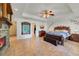 This primary bedroom features a fireplace, tray ceiling, tile floors, and a large decorative mirror at 3225 Hargill Dr, Orlando, FL 32806