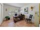 Well-lit office features a large window, vintage desk and chair, as well as tile floors at 3225 Hargill Dr, Orlando, FL 32806