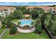 Aerial view showcases community pool surrounded by lush landscaping and beautiful buildings at 3314 Robert Trent Jones Dr # 308, Orlando, FL 32835
