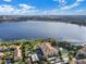 Aerial view of the apartment complex, lake and nearby city at 3314 Robert Trent Jones Dr # 308, Orlando, FL 32835