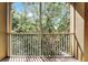 The covered balcony provides a tranquil view of the verdant surrounding trees at 3314 Robert Trent Jones Dr # 308, Orlando, FL 32835