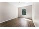 Bright bedroom featuring wood floors and a window providing natural light at 3314 Robert Trent Jones Dr # 308, Orlando, FL 32835