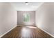 Sunlit bedroom features wood-look floors and neutral walls with a large window at 3314 Robert Trent Jones Dr # 308, Orlando, FL 32835