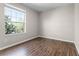 Inviting bedroom bathed in natural light from a large window with hardwood floors at 3314 Robert Trent Jones Dr # 308, Orlando, FL 32835