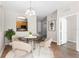 Dining area features round glass table, hardwood floors, and view of the kitchen at 3314 Robert Trent Jones Dr # 308, Orlando, FL 32835