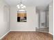 Dining area features hardwood floors, modern lighting and view of the kitchen at 3314 Robert Trent Jones Dr # 308, Orlando, FL 32835