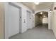 Well-lit hallway featuring elevator access and decorative wall sconces at 3314 Robert Trent Jones Dr # 308, Orlando, FL 32835