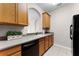 Bright kitchen features tile floors, light wood cabinets, and a black dishwasher at 3314 Robert Trent Jones Dr # 308, Orlando, FL 32835