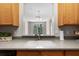 Bright kitchen with light wood cabinets and views into the adjacent living area at 3314 Robert Trent Jones Dr # 308, Orlando, FL 32835