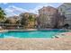 Resort-style pool with lounge seating surrounded by lush, mature landscaping at 3314 Robert Trent Jones Dr # 308, Orlando, FL 32835
