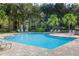 Community pool with plenty of seating, surrounded by lush tropical landscaping at 3314 Robert Trent Jones Dr # 308, Orlando, FL 32835