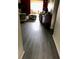 Long view down hallway to living room with luxury laminate flooring at 333 Lake Howard Nw Dr # 302B, Winter Haven, FL 33880