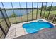 Aerial view of the private pool and spa area with lake view at 36813 Barrington Dr, Eustis, FL 32736