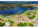 Stunning aerial view of lakefront property in a lush, green community at 36813 Barrington Dr, Eustis, FL 32736