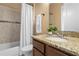 Bathroom with tiled shower and vanity featuring granite countertops and decorative accents at 36813 Barrington Dr, Eustis, FL 32736