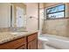 Charming bathroom with granite countertop, wood cabinets, tub and shower at 36813 Barrington Dr, Eustis, FL 32736