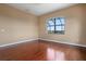 Bright bedroom featuring hardwood floors and a scenic view from the window at 36813 Barrington Dr, Eustis, FL 32736