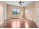 Bedroom with rich wood floors, large window, and a unique octagon-shaped window at 36813 Barrington Dr, Eustis, FL 32736