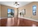 Bedroom with hardwood floors, water views, and access to patio with pool at 36813 Barrington Dr, Eustis, FL 32736