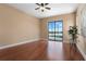 Spacious bedroom with hardwood floors and a large window overlooking a pool and lake at 36813 Barrington Dr, Eustis, FL 32736