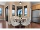 Cozy breakfast nook featuring a round table, white chairs, and a view of the outdoors at 36813 Barrington Dr, Eustis, FL 32736