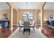 Formal dining room with wood floors, a chandelier, and views of the outdoors through large windows at 36813 Barrington Dr, Eustis, FL 32736