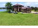 Stunning two-story home boasts a lake view, beautiful landscaping, and a well-manicured lawn at 36813 Barrington Dr, Eustis, FL 32736