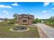 Exterior view of a home with a circular garden at 36813 Barrington Dr, Eustis, FL 32736