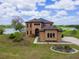 Stunning two-story home with a well-manicured lawn and lake views, perfect for luxurious living at 36813 Barrington Dr, Eustis, FL 32736