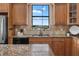 Kitchen area featuring granite countertops, tile backsplash, and stainless steel appliances at 36813 Barrington Dr, Eustis, FL 32736