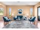 Comfortable living area featuring a stylish sofa, accent chairs, and a modern coffee table on a decorative rug at 36813 Barrington Dr, Eustis, FL 32736