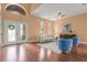 Open-concept living area featuring wood floors, neutral walls, and elegant furnishings at 36813 Barrington Dr, Eustis, FL 32736