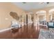 Bright living room showcasing hardwood floors, arched doorways, and stylish decorations at 36813 Barrington Dr, Eustis, FL 32736