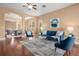 Cozy living room with stylish furniture, hardwood floors, and an open layout for seamless entertaining at 36813 Barrington Dr, Eustis, FL 32736