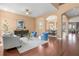 Spacious living room with wood floors, stylish furnishings, and arched doorways leading to other rooms at 36813 Barrington Dr, Eustis, FL 32736