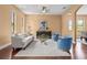 Bright living room showcasing hardwood floors, modern décor, and large windows for ample natural light at 36813 Barrington Dr, Eustis, FL 32736
