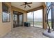 Covered patio area with stone flooring, translucent windows and glass paneled doors at 36813 Barrington Dr, Eustis, FL 32736