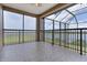 Tiled patio overlooking fenced yard with lake view from home at 36813 Barrington Dr, Eustis, FL 32736