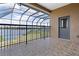Enclosed tiled patio overlooking scenic backyard with lake and fence at 36813 Barrington Dr, Eustis, FL 32736