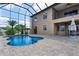 Backyard pool with screened enclosure, palm trees, and outdoor patio area at 36813 Barrington Dr, Eustis, FL 32736