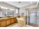 This bathroom has a double vanity, a soaking tub, and a walk-in shower at 3714 Marigot Way, Clermont, FL 34711