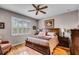 This bedroom features plantation shutters, a ceiling fan, and wood floors at 3714 Marigot Way, Clermont, FL 34711